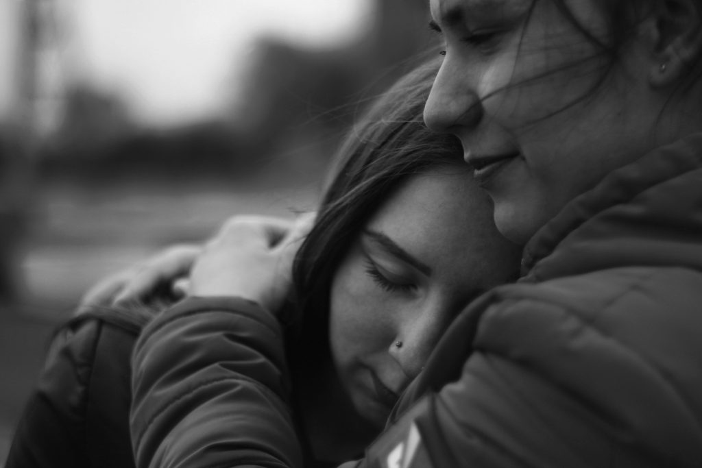woman hugging another woman